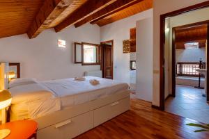 a bedroom with a large bed and a bathroom at Elegant Attic-Rovigo Center-6 people in Rovigo