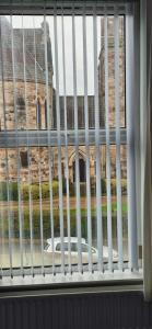 a view of a building through a barred window at Private Room in Eglantine Avenue in Central Belfast in Belfast +9 photos