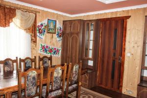a row of chairs in a room with wooden walls at Сільська садиба in Yablunytsya +11 photos