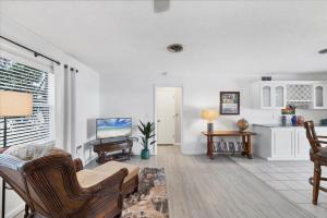 a living room with white walls and wooden furniture at 27305 Voyageur in Punta Gorda