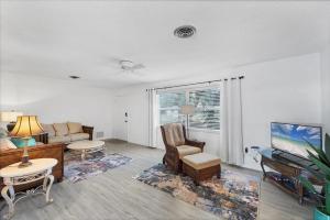 a living room with a couch and a tv at 27305 Voyageur in Punta Gorda +36 photos