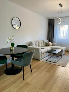 a living room with a couch and a table at FILIP Lux Apartman sa garažom in Doboj