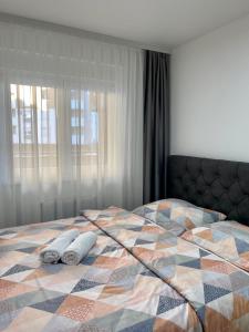 a bedroom with a bed with two towels on it at FILIP Lux Apartman sa garažom in Doboj