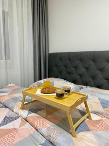 a tray of food on a table on a bed at FILIP Lux Apartman sa garažom in Doboj +8 photos
