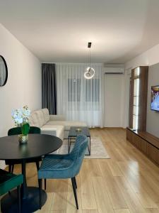 a living room with a couch and a table at FILIP Lux Apartman sa garažom in Doboj