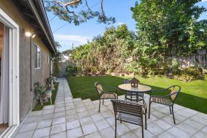 a patio with a table and chairs and a yard at Seashore Delight in San Diego