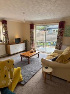 East HarlingにあるThe Wright Midweek stayのソファとテーブルのあるリビングルーム