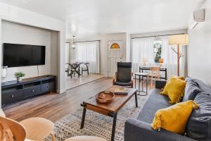 a living room with a couch and a table at Seashore Delight in San Diego +15 photos