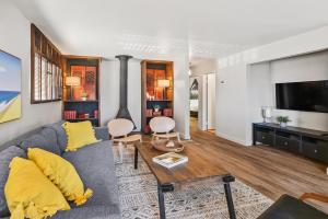 a living room with a couch and a tv at Seashore Delight in San Diego