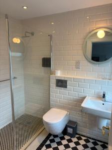 a bathroom with a toilet and a sink and a shower at Gilberts Townhouse in Cobh +12 photos