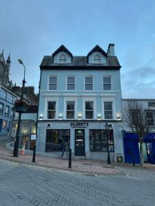 a blue building on the corner of a street at Gilberts Townhouse in Cobh