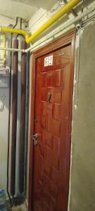 a wooden door with the number on it at Cazare in Deva