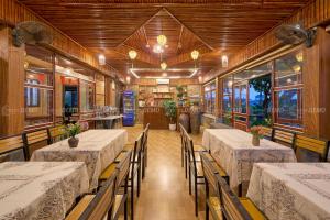 a dining room with tables and chairs in a restaurant at TamCoc Moon An Bungalow & Cafe in Ninh Binh