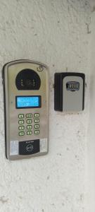 a cell phone is attached to a wall at Cazare in Deva