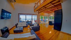 a large living room with a view of the ocean at Casa Playa Almendro, Tela, Honduras 