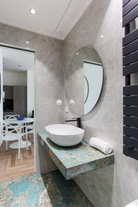 a bathroom with a sink and a mirror at YLS Luxury Suites 2 in Milan +41 photos