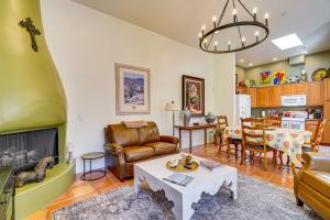 a living room with a couch and a table at Sunny Adobe Retreat with Hot Tub and Mtn Views! in Tubac
