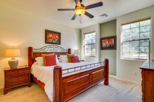 a bedroom with a bed and a ceiling fan at Sunny Adobe Retreat with Hot Tub and Mtn Views! in Tubac +26 photos