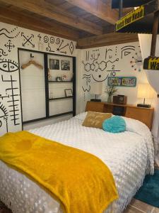 a bedroom with a bed with a yellow blanket at Go Glamping in Athens, Georgia, in this Cozy Tiny House for Four in Athens