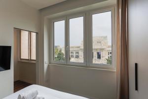 a bedroom with a window with a view of a building at YLS Luxury Suites 2 in Milan