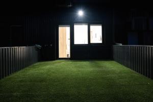 a dark room with a door and a window at Color Avenida T0 in Águeda