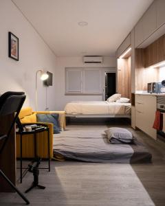 a room with two beds and a desk in it at Color Avenida T0 in Águeda +24 photos