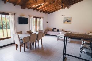 a living room with a table and chairs and a couch at Check and Home - Chapa - 5 huéspedes con patio y parrilla in Chapadmalal