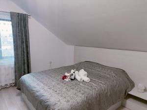a bedroom with a bed with stuffed animals on it at Colț de lavandă in Braşov