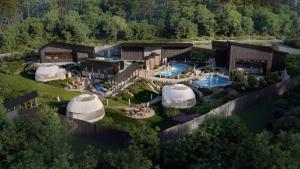 an aerial view of a resort with a swimming pool and tents at Everwild Canmore - Nordic Spa & Hotel in Canmore
