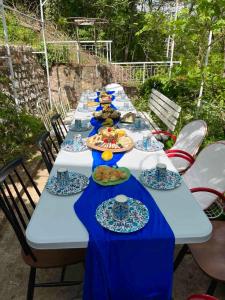 a long table with plates of food on it at Viva Sićevo in Železnička Stanica Sićevo +48 photos