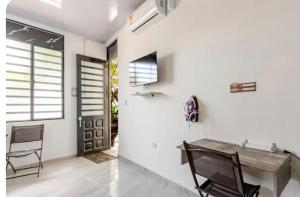 a room with white walls and a table and chairs at Air b&b altos del peñon in Girardot
