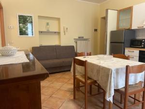 a kitchen and living room with a table and a couch at Fior Di Sambuco in Broni