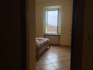 a small room with a bed and a window at Fior Di Sambuco in Broni