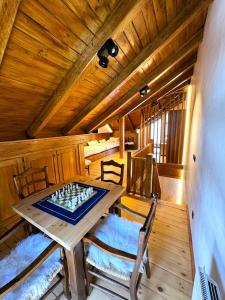 a room with a chess board on a wooden table at AC Apartaments Tarter Chalet in El Tarter +15 photos