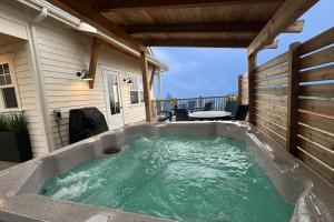a hot tub on the back of a house at Pacific Perch in Depoe Bay