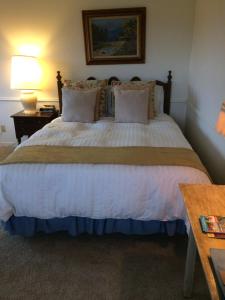 a bedroom with a large bed and a table at Elegant suite-30 day minimum in Carmel