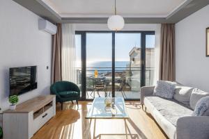 a living room with a couch and a table at Adriatic Masterpiece Residence in Sveti Stefan