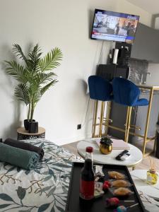 een woonkamer met een tafel en een dienblad met eten bij Tiny house - piscine et vélos in Vasselay