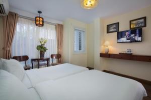 Giường trong phòng chung tại Classic Street Hotel