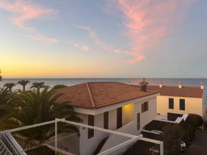 a view of a house with the ocean in the background at Los Azahares Apartment in Costa Del Silencio
