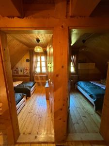 a room with two beds in a wooden house at Ujsoły Chill House w Beskidach, Beskid Żywiecki in Ujsoły +29 photos