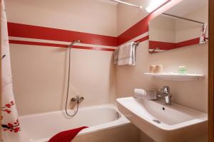 a bathroom with a white tub and a sink at Appartementhaus Montana KG in Walchsee +37 photos