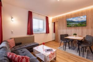 a living room with a couch and a table at Appartementhaus Montana KG in Walchsee