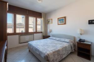 Ένα ή περισσότερα κρεβάτια σε δωμάτιο στο Hotel Caldin's