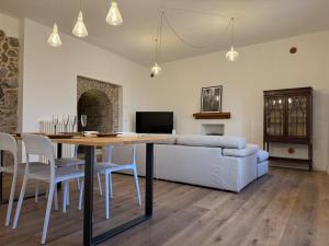 a living room with a table and a couch at Sara Home in Guarene