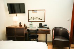 a hotel room with a desk and a chair at Villa Admiral in Gdynia