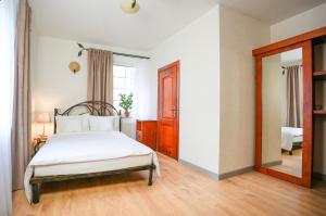a bedroom with a bed and a mirror at Villa Admiral in Gdynia +55 photos