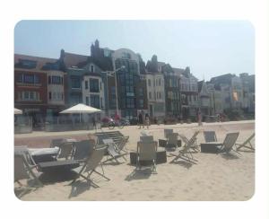 a group of chairs and umbrellas on a beach at Secteur digue Dunkerque, Escale a Malo, Aquae Mare in Dunkerque