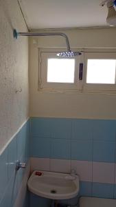 a bathroom with a toilet and a window at Beach House - Mar de Taganga in Taganga +10 photos