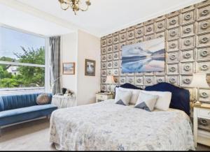 a bedroom with a bed and a large window at Invergarry Room Only Guest House For Adults in Windermere